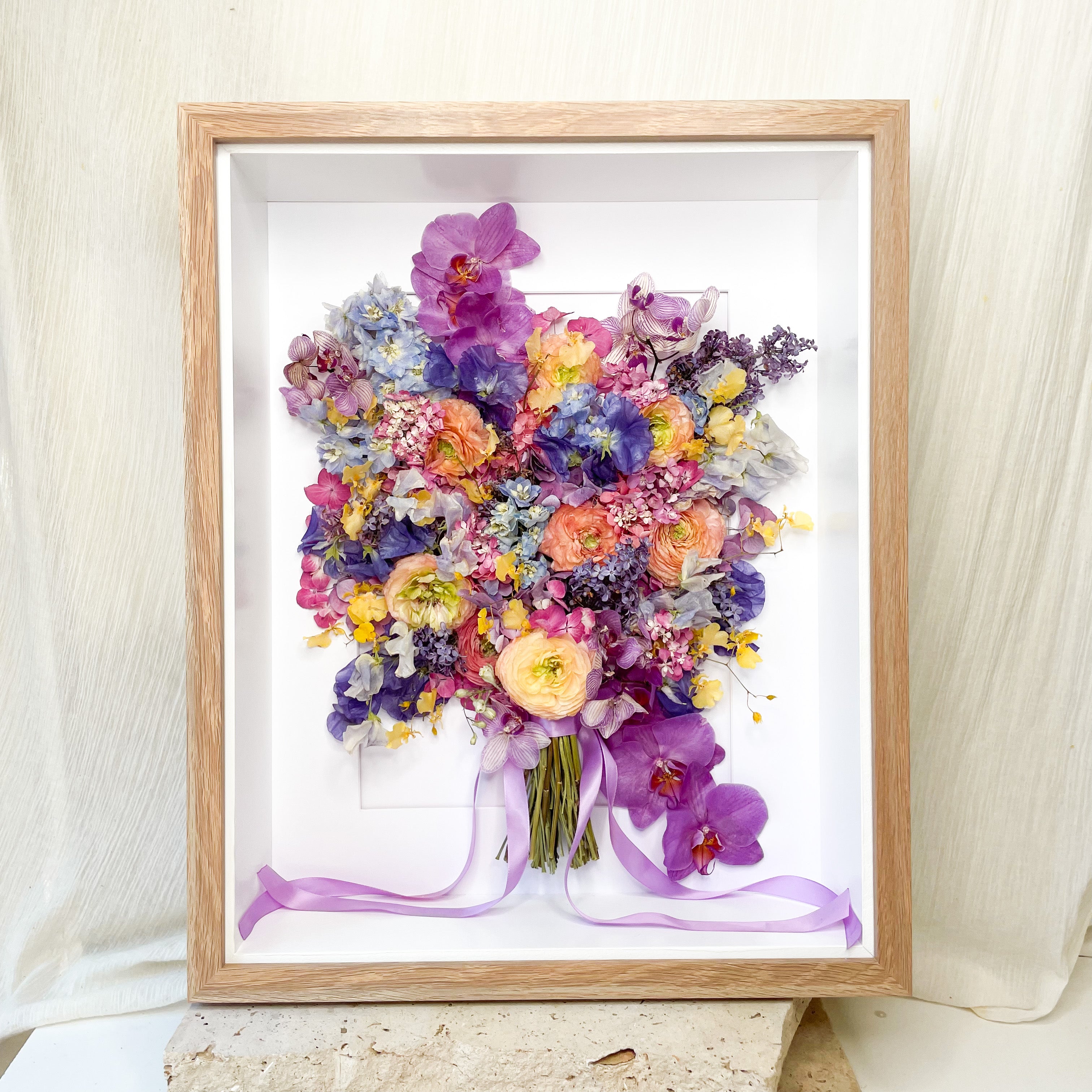 custom-flower-framing-3d-shadow-box
Preserved bright colourful purple blue yellow wedding bouquet set in 40x50cm 3d oak frame