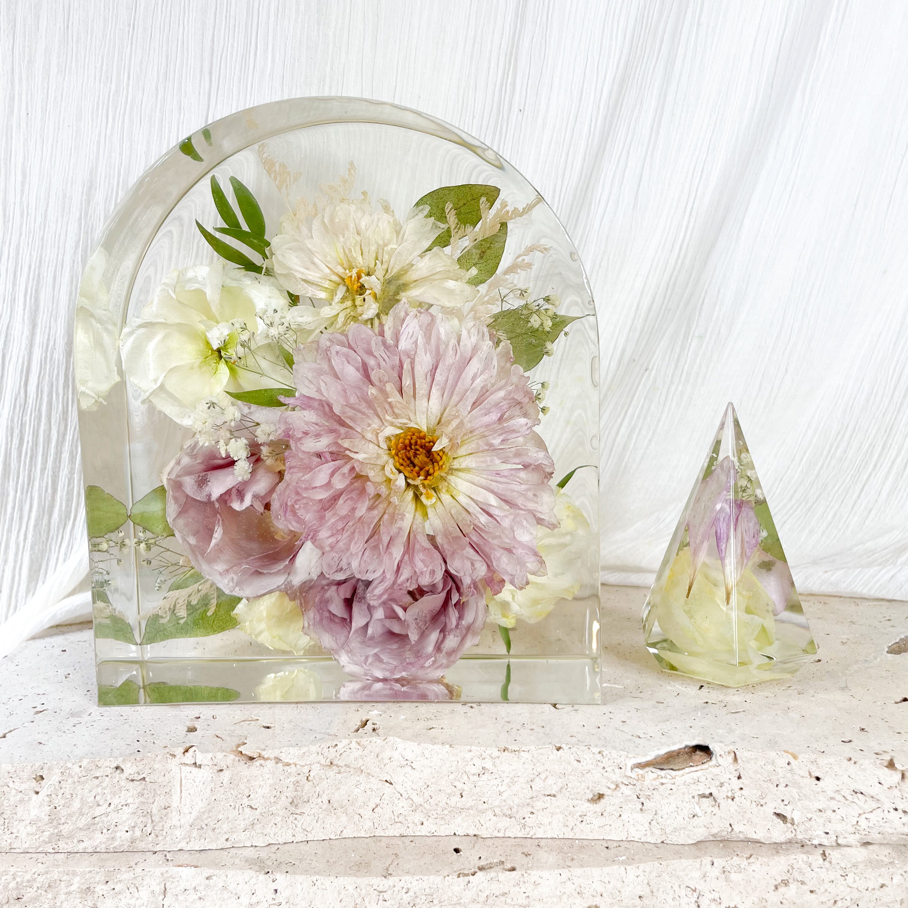 Preserved wedding flowers in large resin arch and ring holder