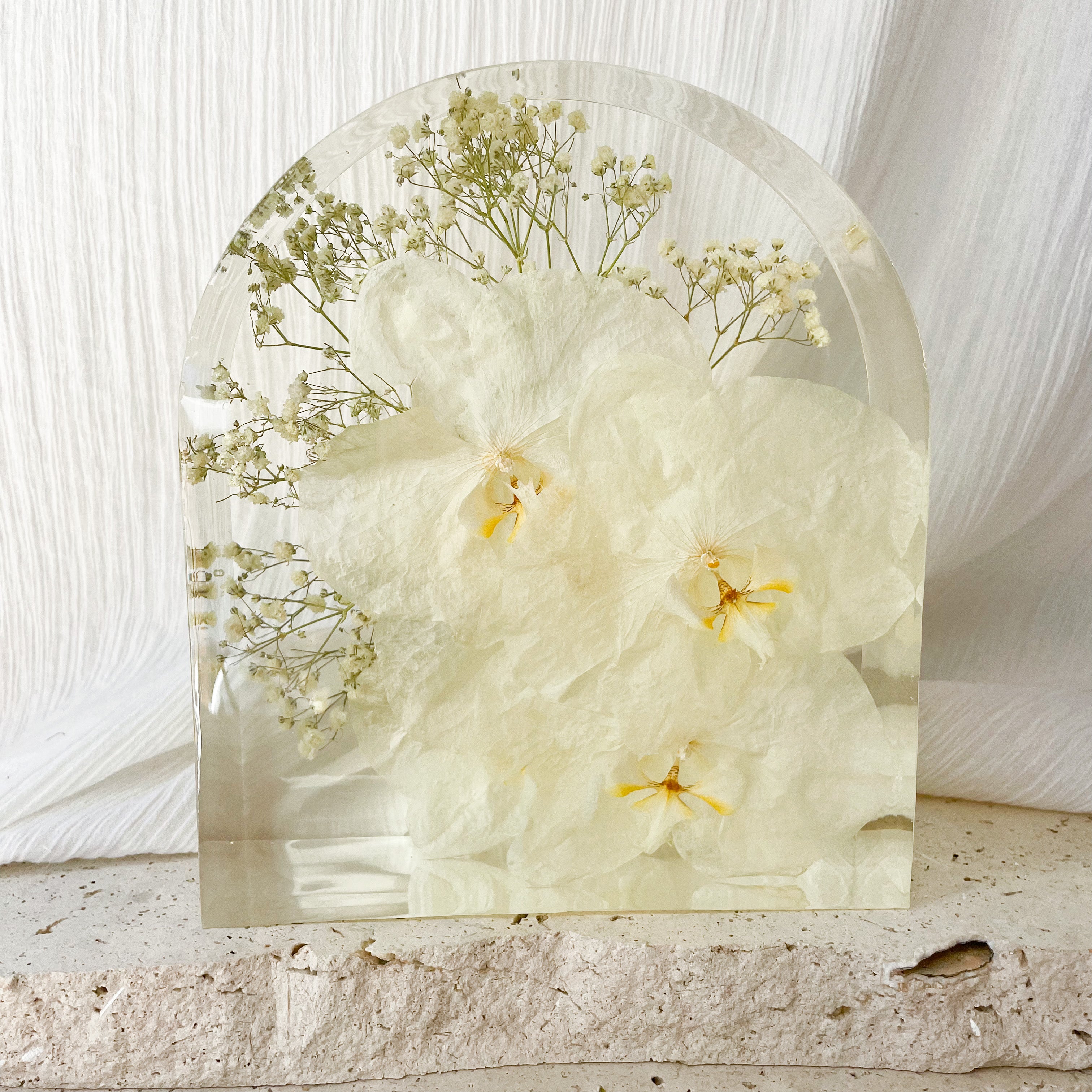 Preserved white wedding flowers in large resin arch block