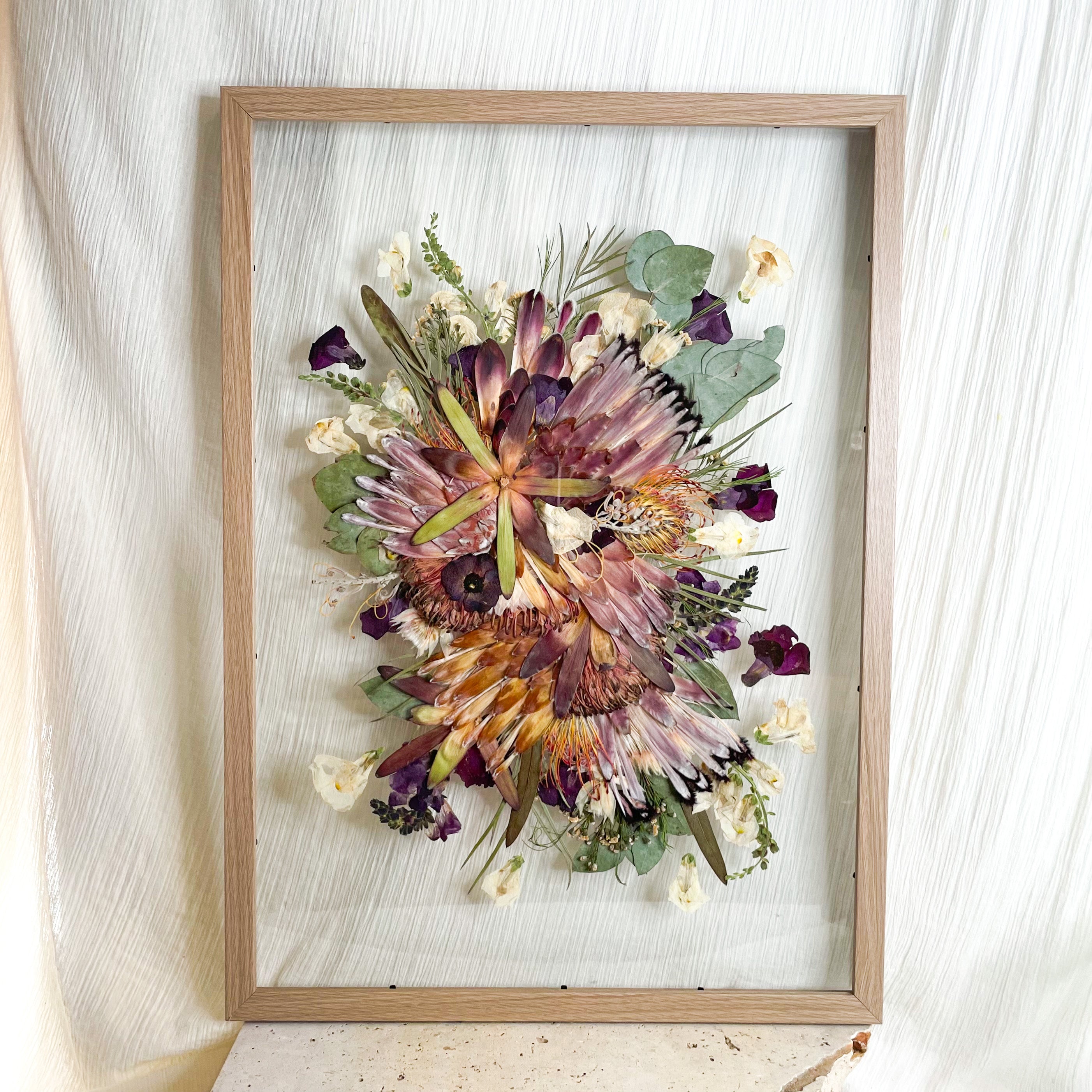 Preserved pressed native wedding bouquet - protea flowers and gum set inside a floating frame mount