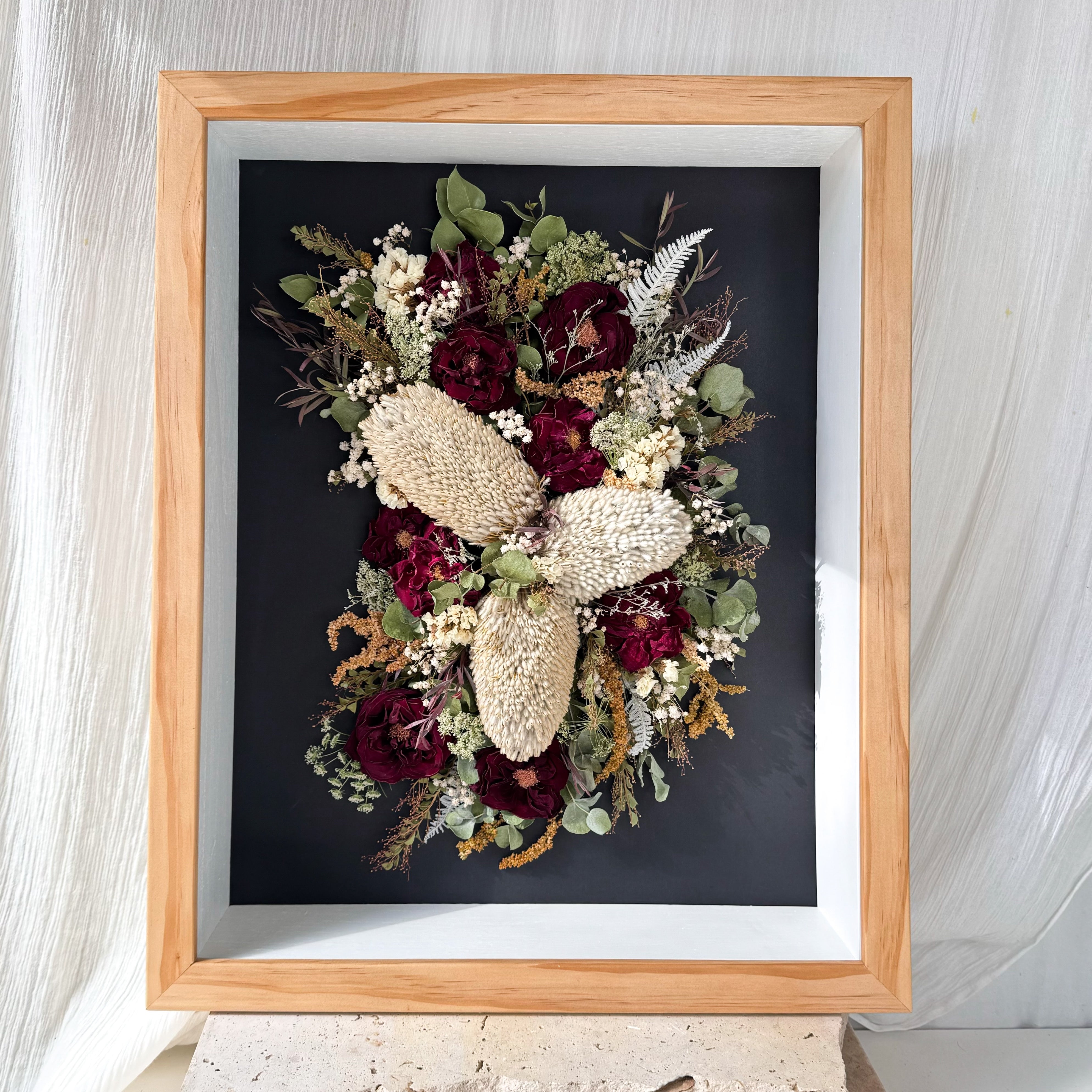 custom-flower-framing-3d-shadow-box
Preserved banksia, red rose and gum wedding bouquet set in crescent moon shape 40x50cm 3d oak frame black mat board