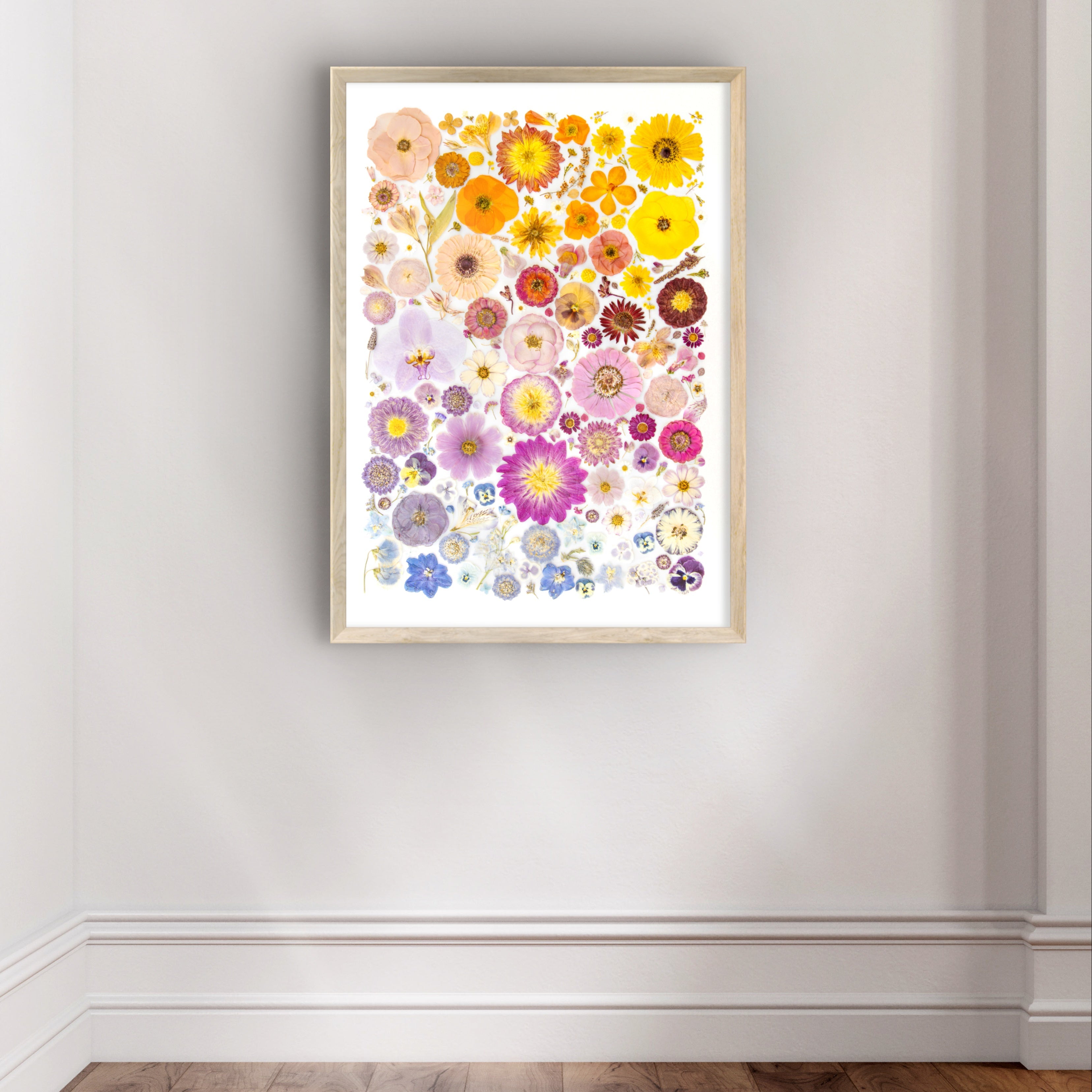 Framed floral artwork on a white wall with wooden floor