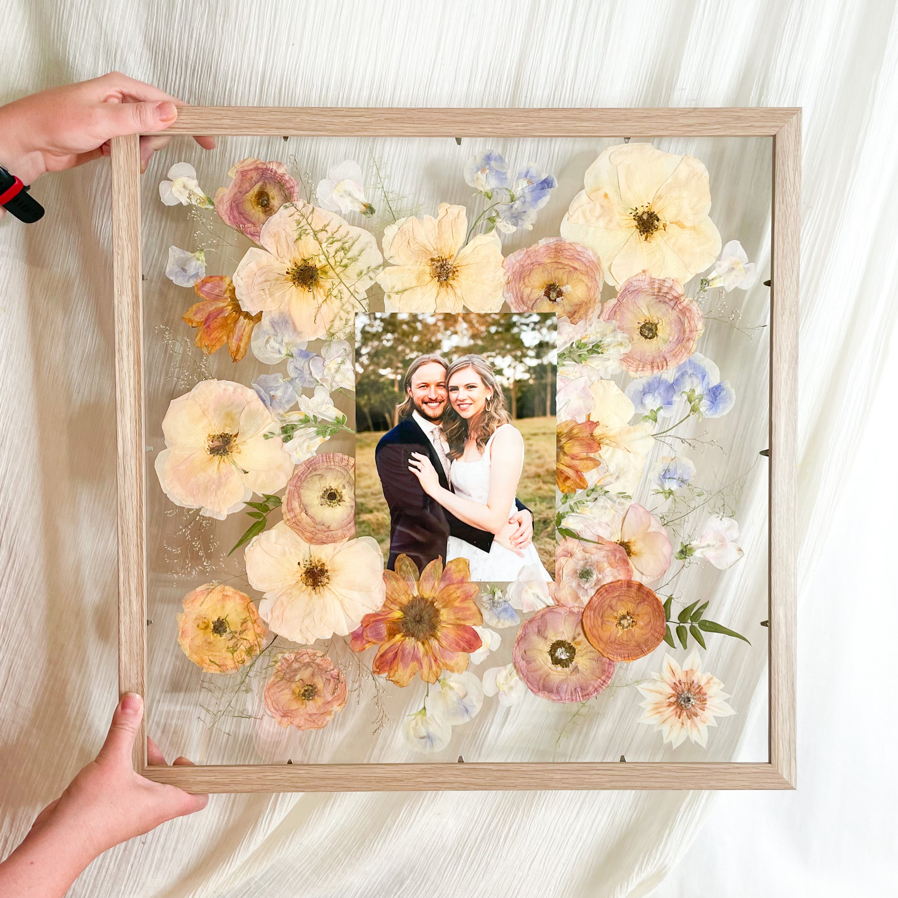 Pressed wedding bouquet preserved flowers in floating frame mount with wedding photo