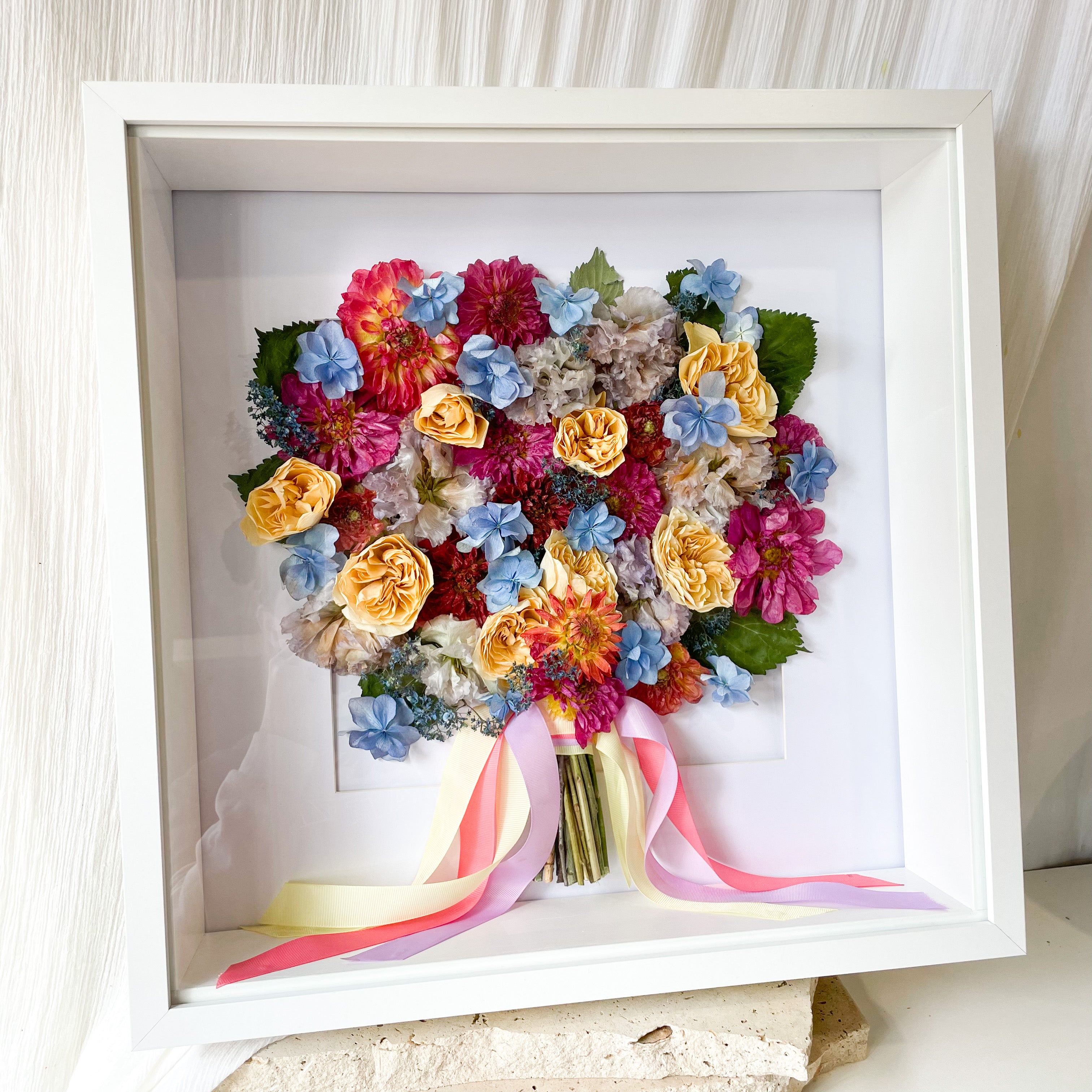 custom-flower-framing-3d-shadow-box
Preserved bright dahlia, rose, hydrangea wedding bouquet set in 50x50cm 3d white frame