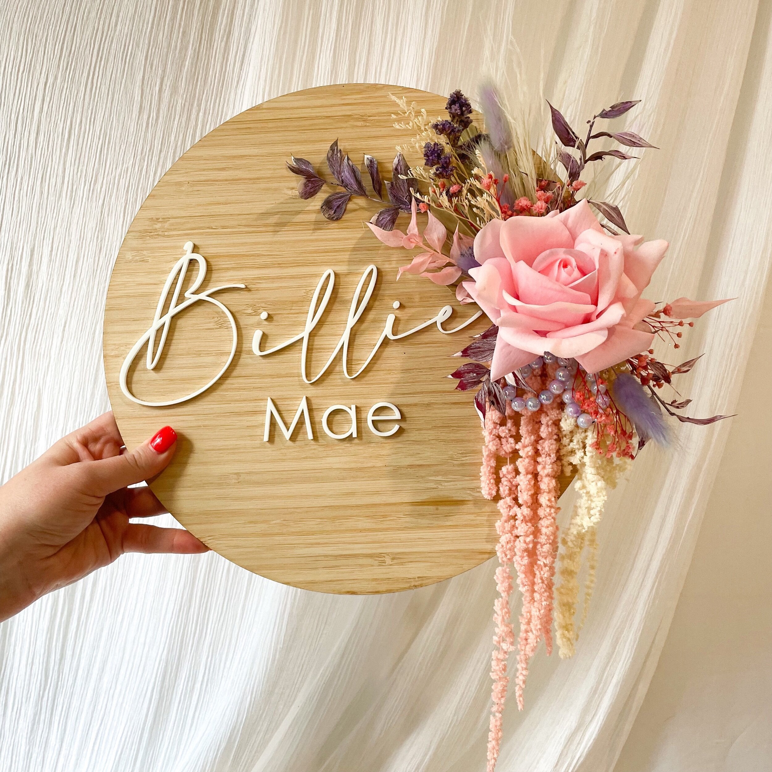 dried flowers set on timber name plaque